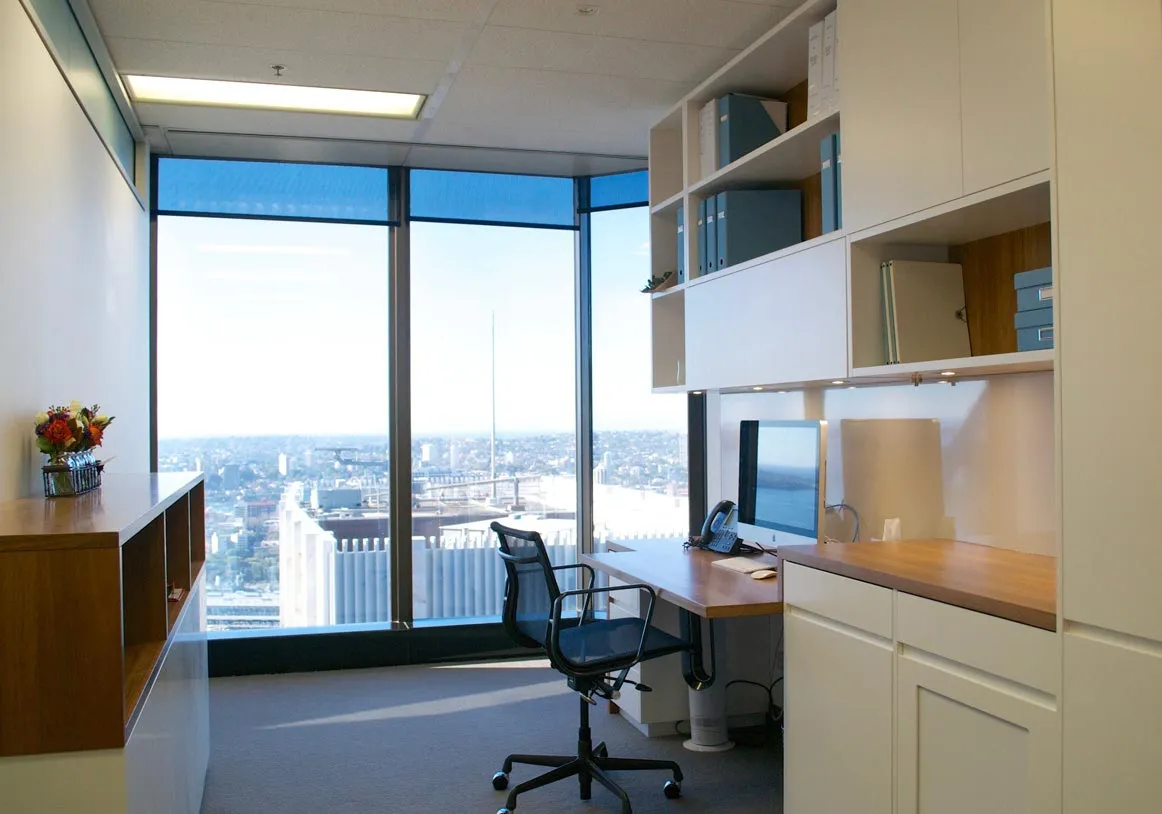 A modern office setup featuring a desk, a chair, and a cabinet, creating a functional workspace