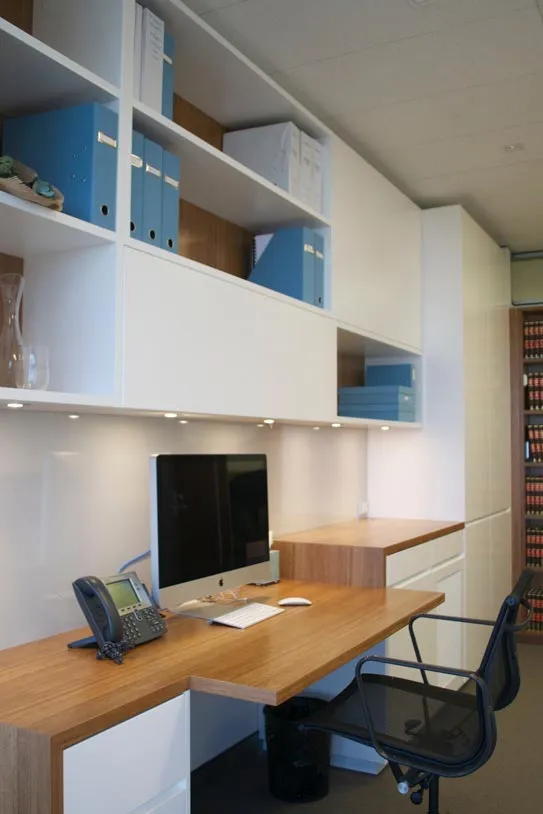 A well-lit home office showcasing a desk beside a window, perfect for productivity and natural light