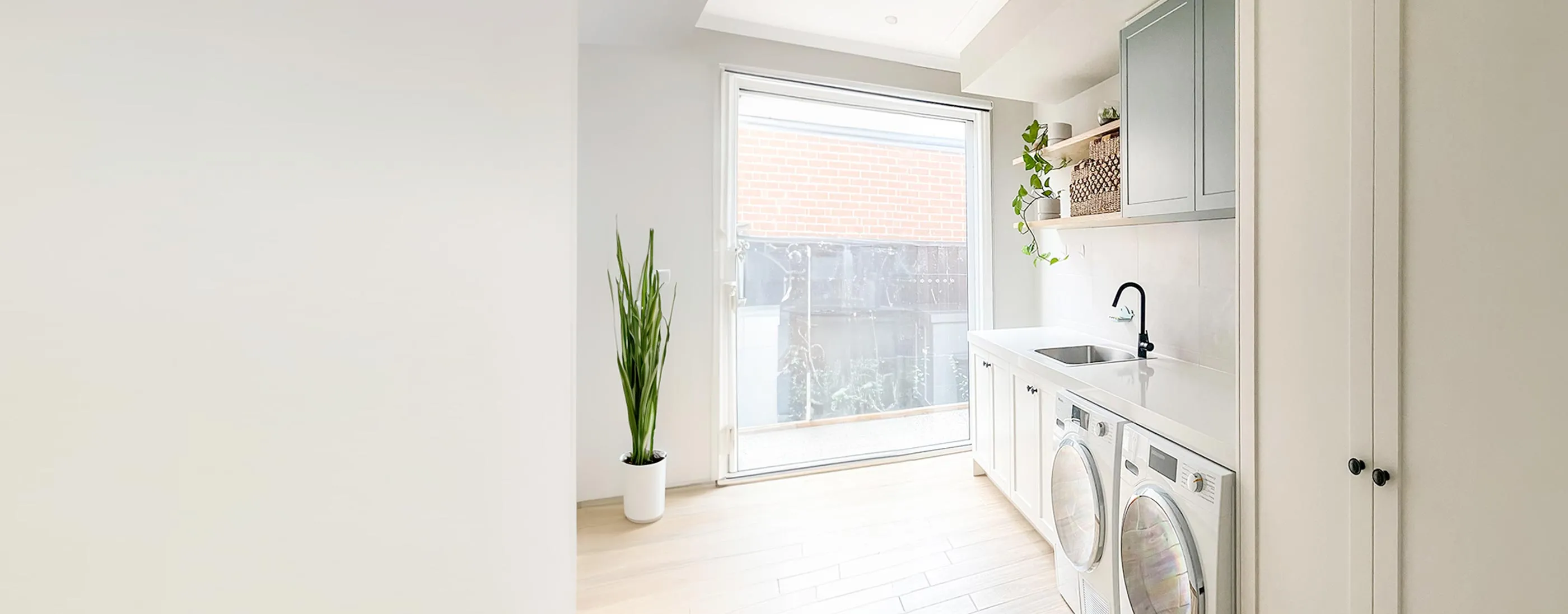A tidy laundry room featuring a modern washer and dryer, ready for efficient laundry tasks